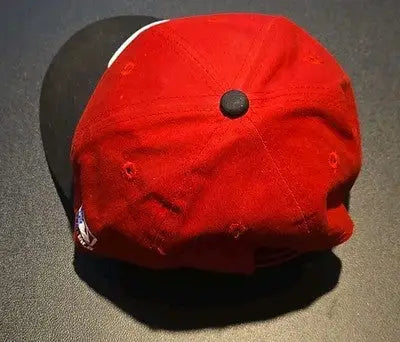 Red and black Cincinnati Reds baseball cap with small writing inside from Elly graded lot