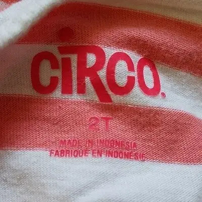 Pink and white striped fabric label on Circo Girls long sleeve scoop neck top