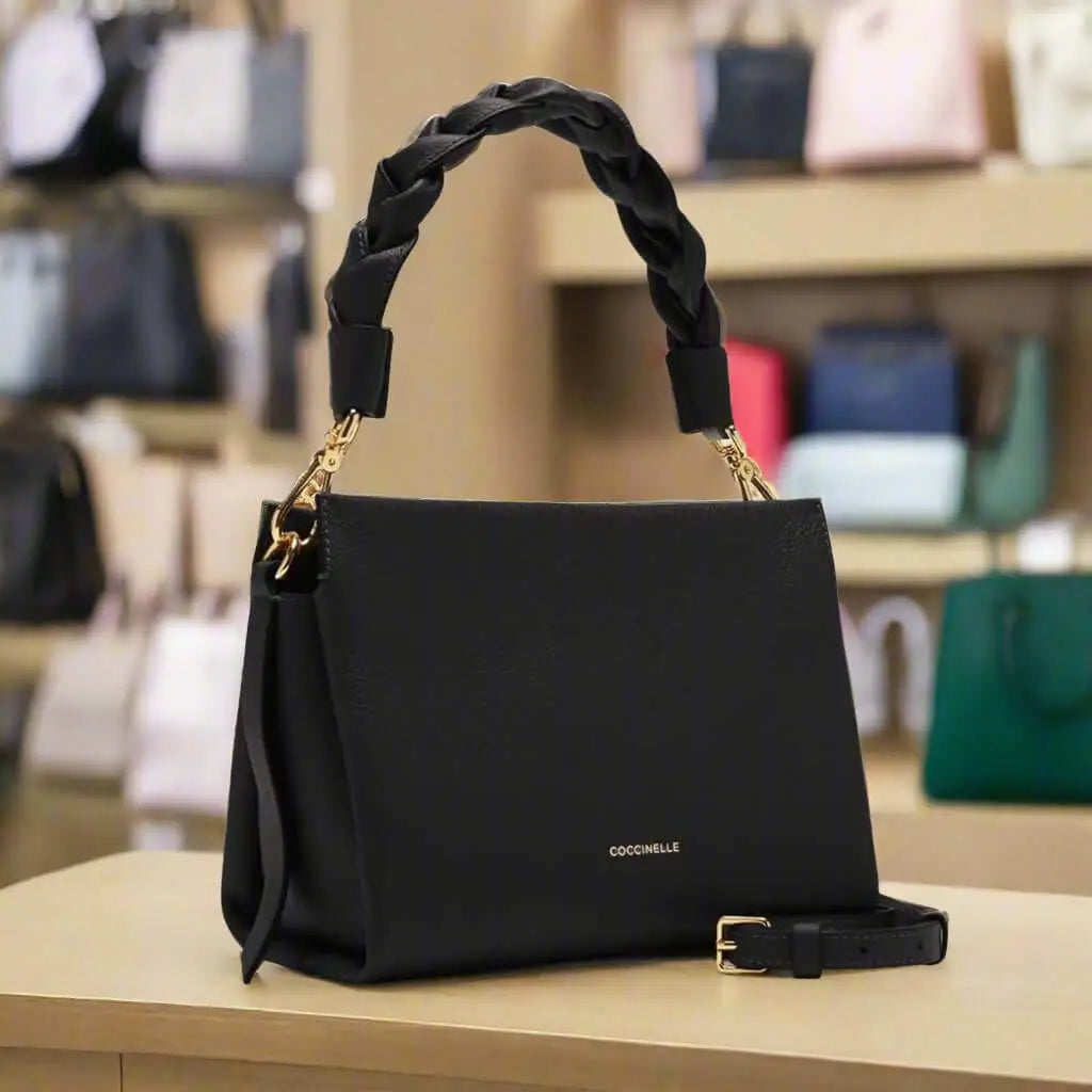 Black leather handbag with braided top handle and adjustable shoulder strap for women