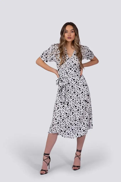 Coco Dress White Polka Dot featuring a white midi wrap dress with black polka dots and puff sleeves