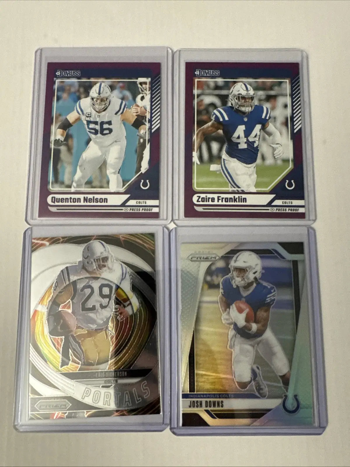 Four Indianapolis Colts sports trading cards in protective sleeves from Colts 13 Card Lot featuring Peyton Manning