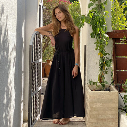 Woman wearing cotton silk long maxi dress with tie-waist and turquoise watch
