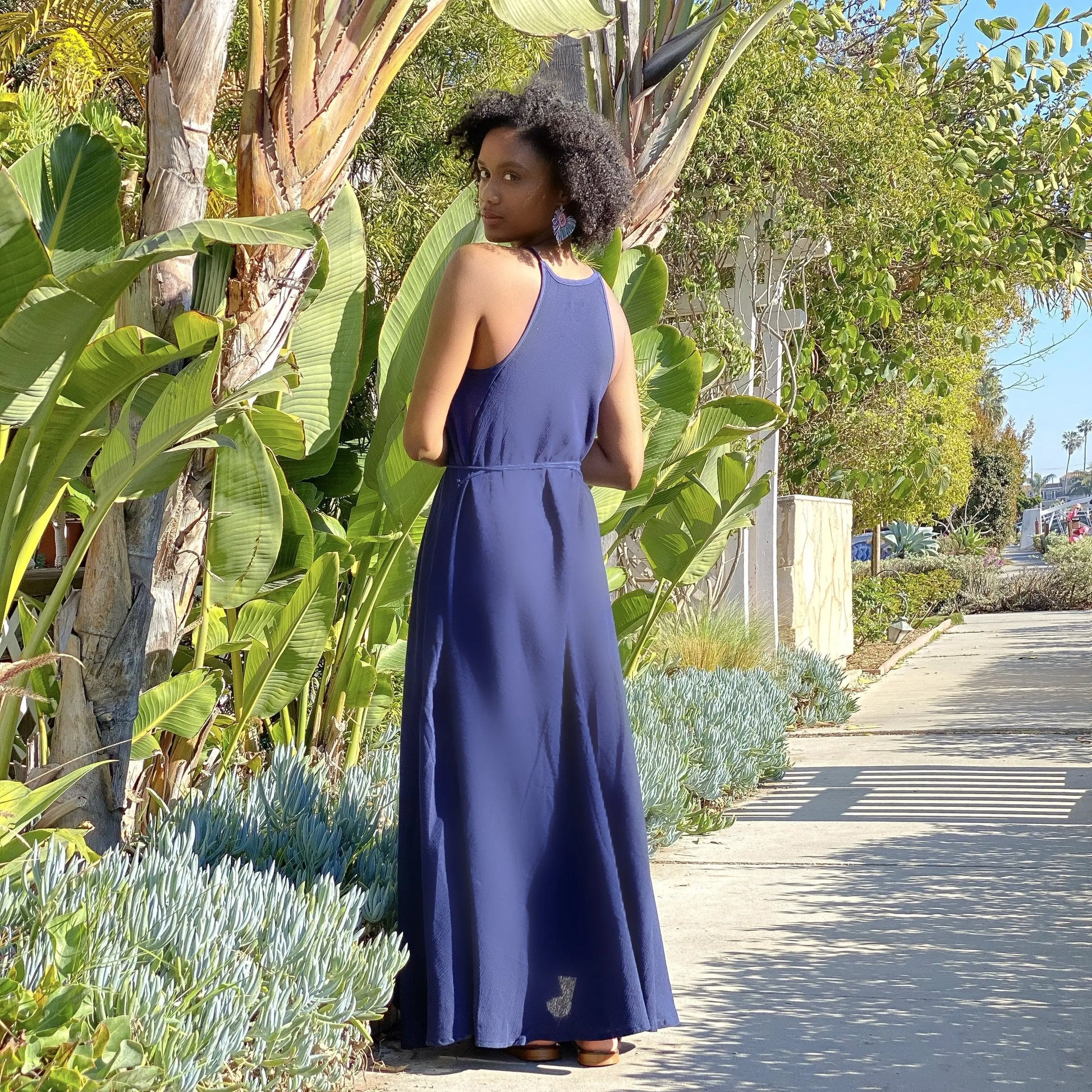 Woman in a navy blue cotton silk long maxi dress with thin straps