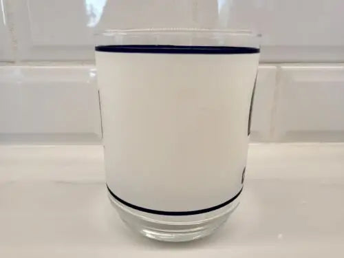 White frosted glass tumbler with blue trim and Dallas Cowboys helmet logo design