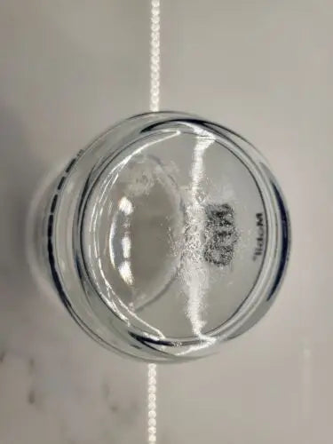 Clear glass jar bottom of Dallas Cowboys Frosted Glass Rocks Tumbler with helmet logo