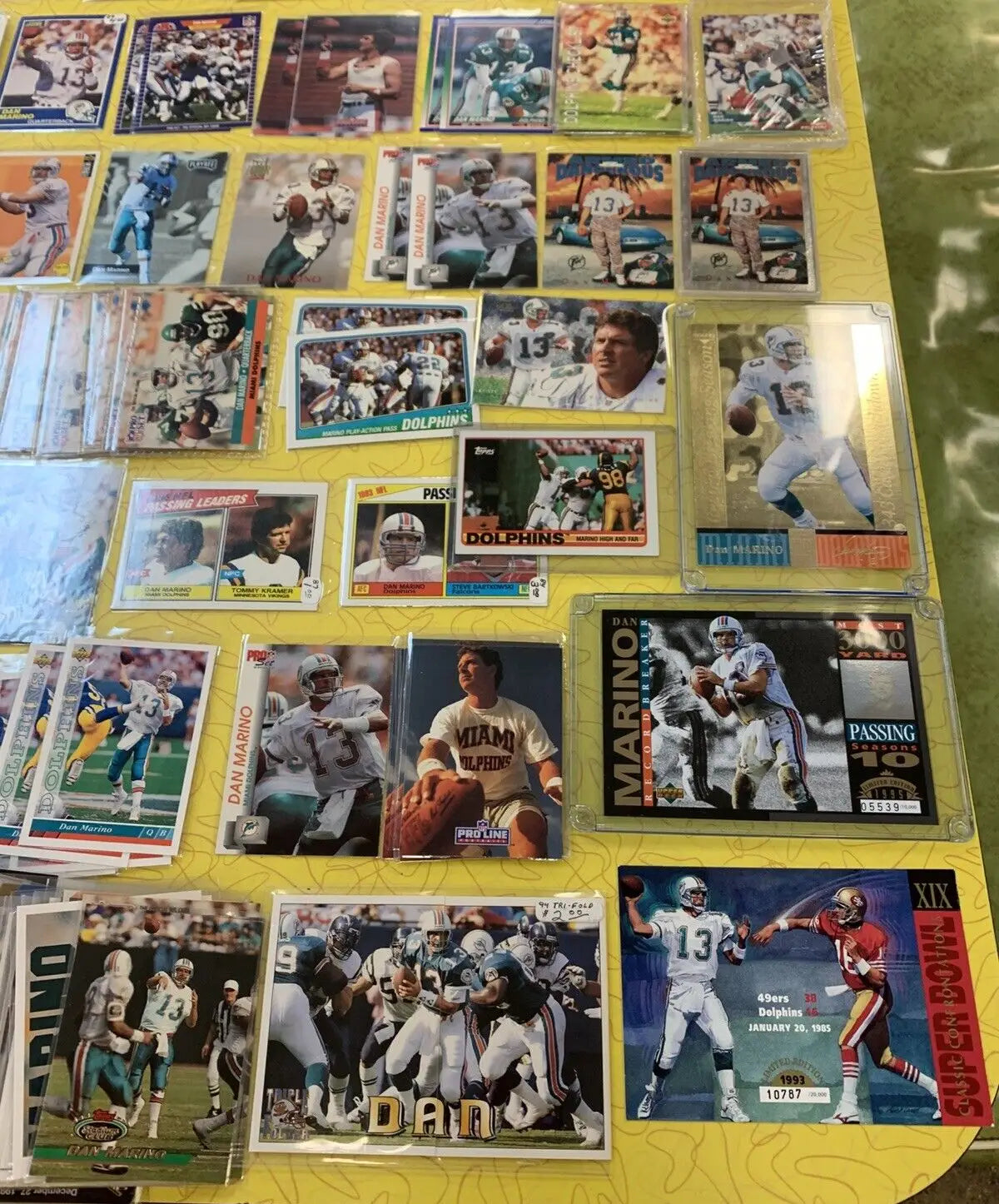 Collection of Dan Marino Miami Dolphins football cards, including Upper Deck and Topps inserts