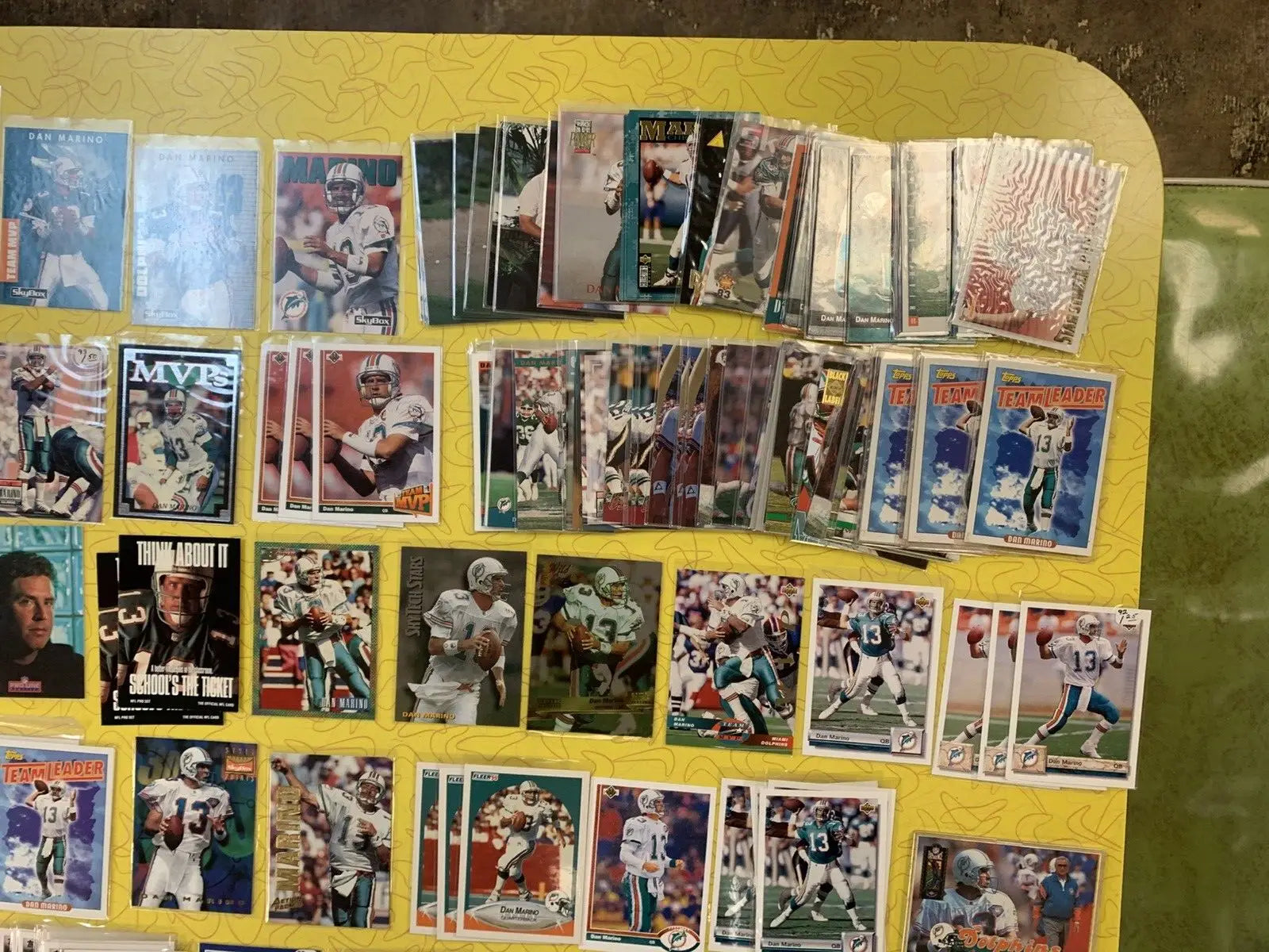 Assorted sports trading cards featuring Dan Marino and Miami Dolphins collectibles