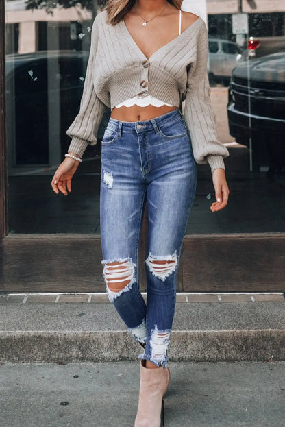 Woman wearing beige cropped cardigan and Dark Blue Washed Distressed Slits Skinny Jeans