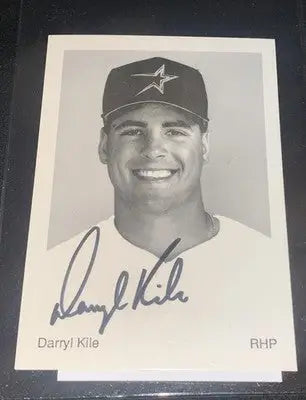 Black and white autographed baseball card of smiling Houston Astros pitcher from team issue