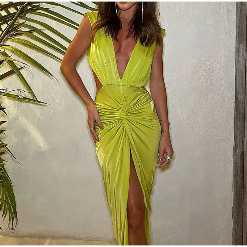 Woman in vibrant chartreuse deep V neck midi dress with knotted front and high slit