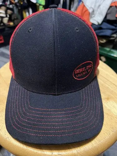 Black and red Dirt Inc Trucker SnapBack Hat with oval logo front view