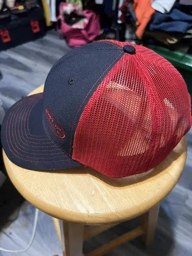 Dirt Inc Trucker SnapBack Hat with dark blue front and bill, red mesh back