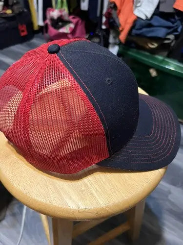 Dirt Inc Trucker SnapBack Hat with black front and brim, red mesh back