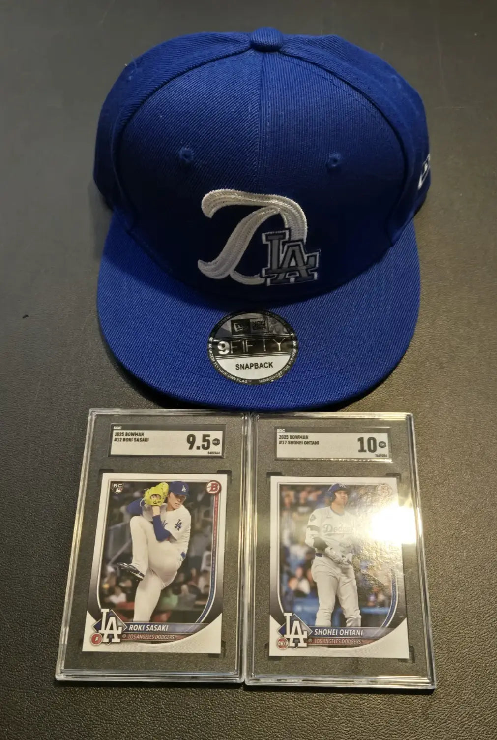 Blue Los Angeles Dodgers cap with graded Roki Sasaki and baseball cards, Era 9FIFTY snapback