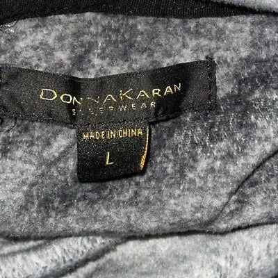 Donna Karan sleepwear label sewn onto gray fabric of soft loungewear pullover top