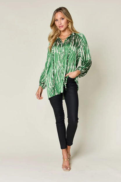 Green tie-dye long sleeve shirt with size printed button details, paired with black jeans and beige sandals