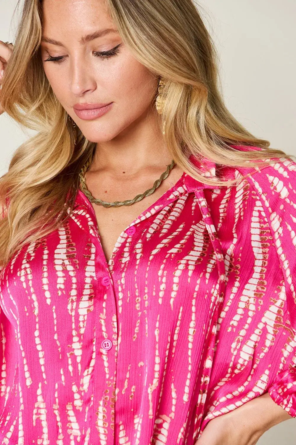 Pink tie-dye long sleeve shirt with printed buttons and a size printed design