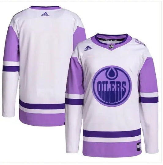 Edmonton Oilers hockey jersey displayed on a white and purple practice jersey