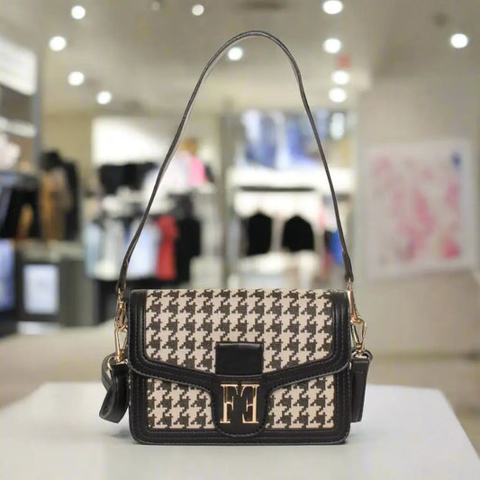 Black and beige houndstooth shoulder bag with gold clasp and shoulder strap from Egon Von Furstenberg