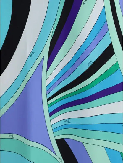 Vibrant abstract patterned fabric in shades of blue green purple black on Emilio Pucci Iride print long dress