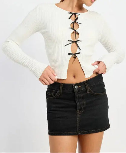 White long sleeve ribbed knit crop top with black bow accents from Emory Park in ivory