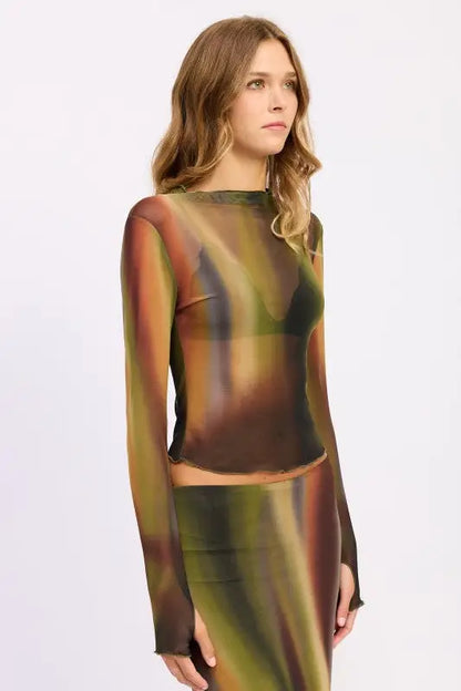 Woman modeling Emory Park long sleeve mesh lounging top with abstract swirl pattern and matching midi skirt