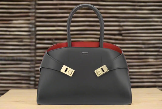 Ferragamo black red hug handbag with dark gray leather, red lining, and gold hardware