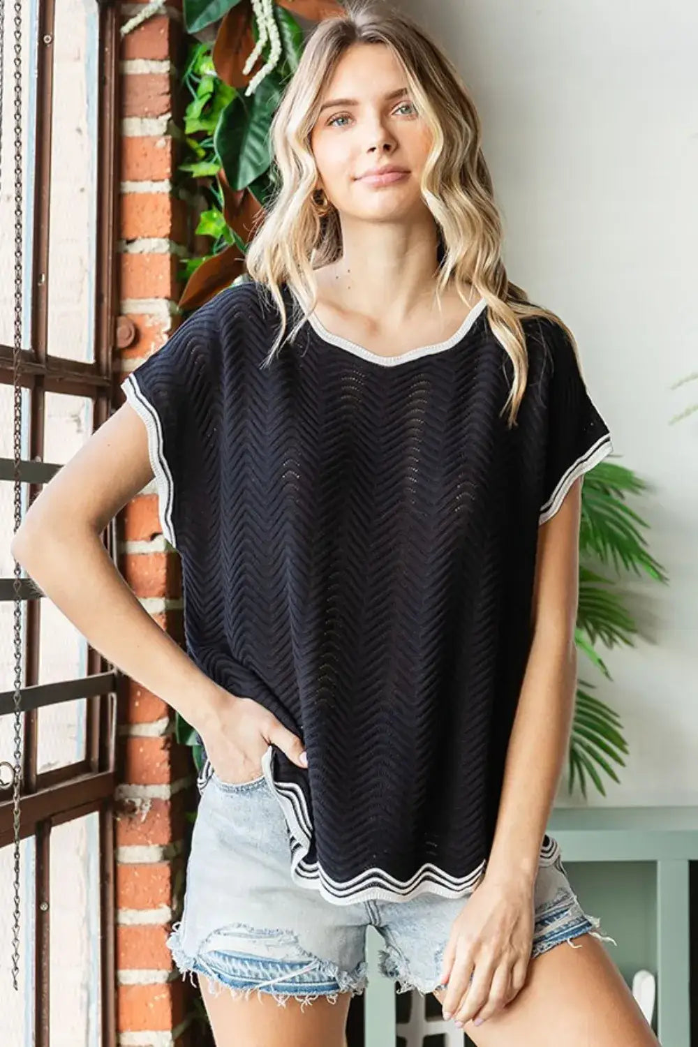Black and white striped trim knit top with short sleeves featuring wavy crochet drop shoulder design