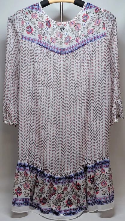 White sheer bohemian long sleeve floral dress with leaf print, floral yoke, and ruffled hem