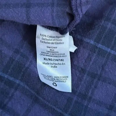 Purple plaid shirt with white label, part of Free Assembly Girls Plaid Dress collection