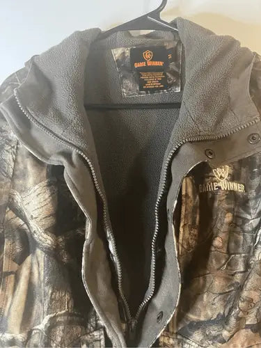 Camo-patterned hunting jacket with grey fleece lining and zipper closure in Game Winner Heavy Lined Coat