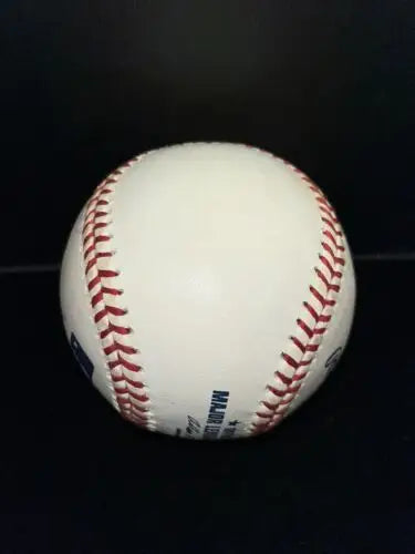 White baseball with red stitching, Gene Stallings autographed baseball for collectors