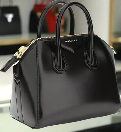 Shiny black leather GIVENCHY Antigona mini handbag with top handles and gold zipper