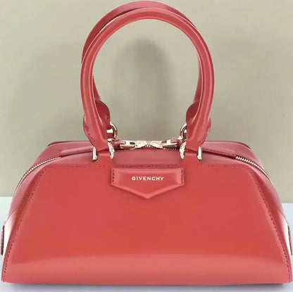 Shiny red Givenchy Antigona East West mini handbag with top handles and zipper closure