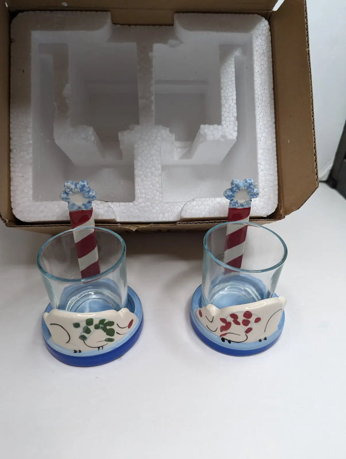 Two glass candle holders featuring frog and candy cane designs from Gold Canyon Votive set