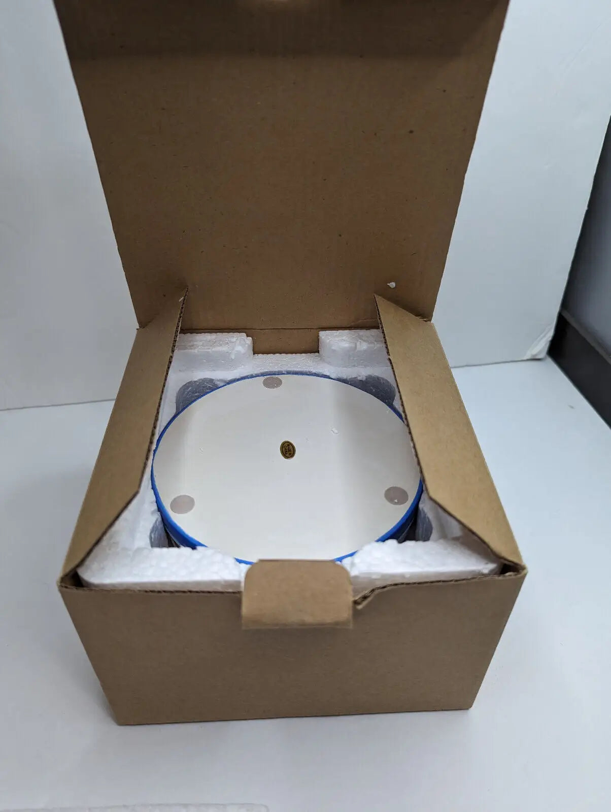 Round white turntable in box showcasing Gold Canyon Votive/Pillar Candle Holders