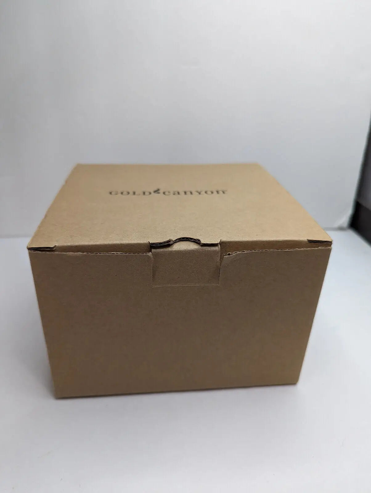Closed cardboard box containing Gold Canyon Votive Pillar Candle Holders Snow Bears Set
