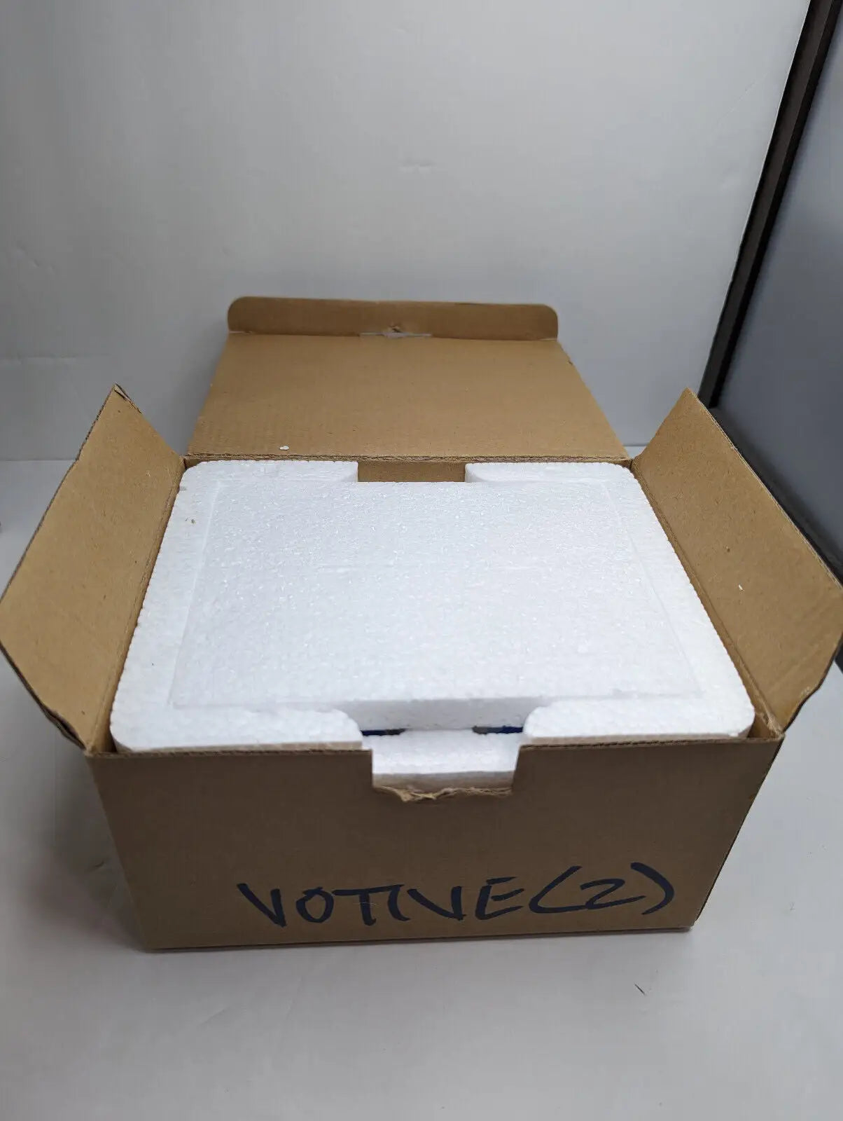 Open cardboard box with styrofoam insert for Gold Canyon Votive Pillar Candle Holders