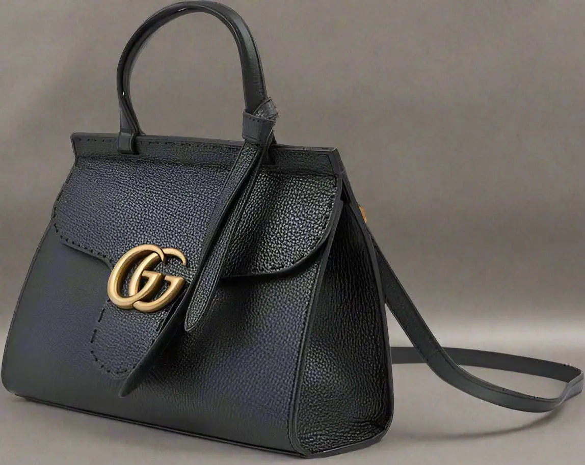 Black leather GG Marmont handbag with gold GG logo and shoulder strap