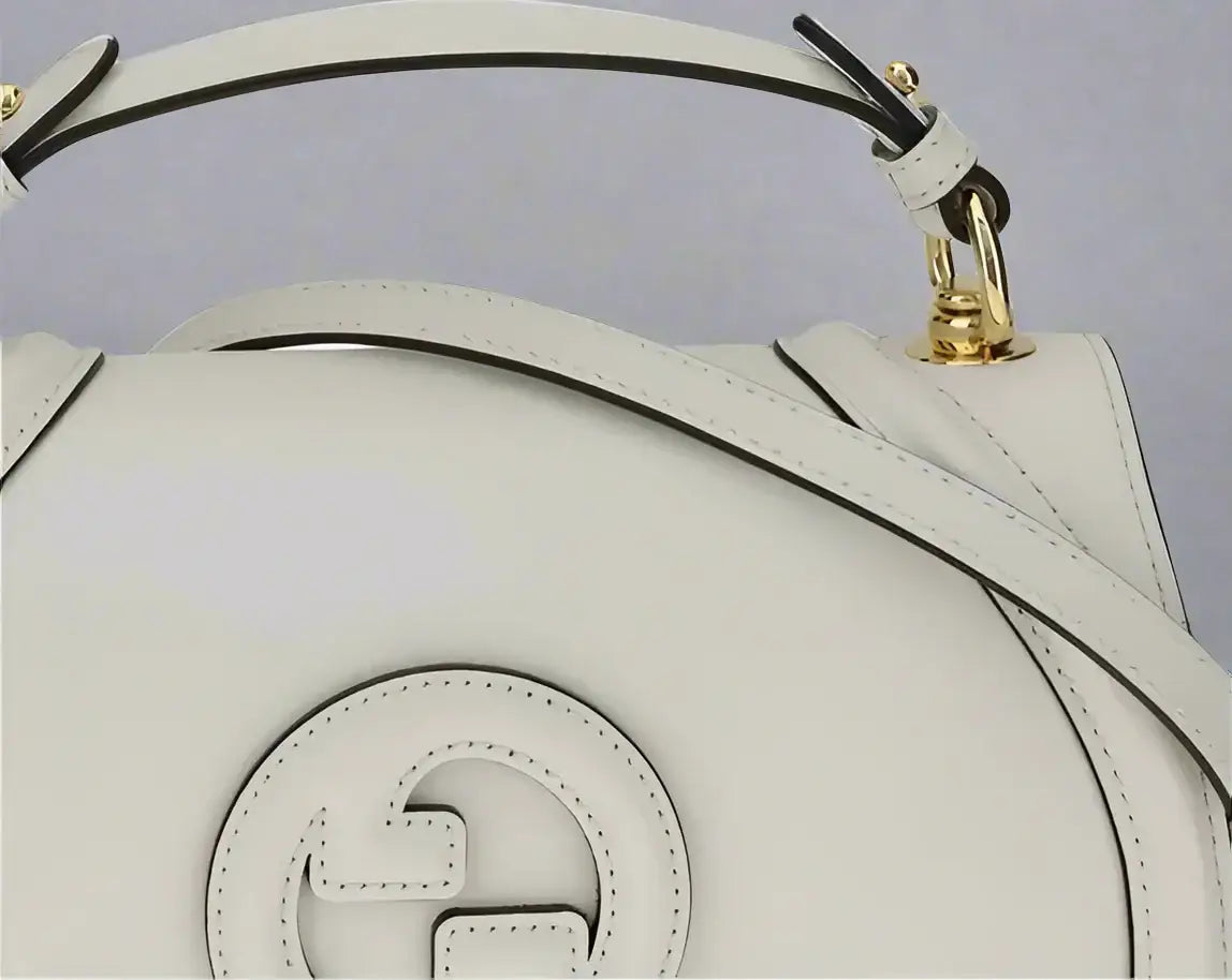 Gucci Blondie Handbag with tonal white leather, interlocking G logo, and gold hardware