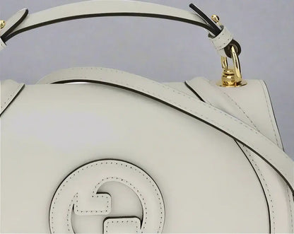 Gucci Blondie Handbag with tonal white leather, interlocking G logo, and gold hardware