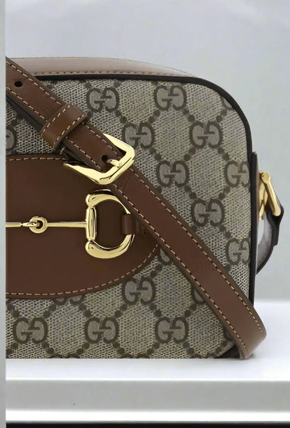 Gucci Horsebit 1955 shoulder bag with brown and beige monogrammed design and gold horsebit detail