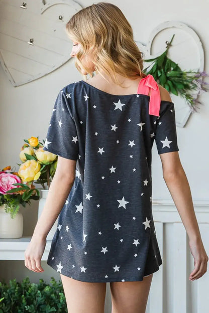 Dark grey star print asymmetrical short sleeve top with pink bow on shoulder