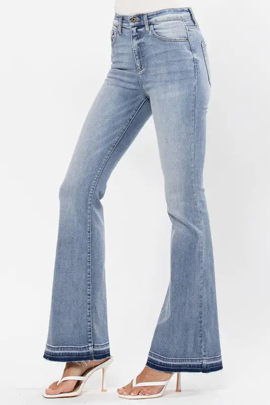 Light wash high rise flare jeans with raw cut hem and bottom detail