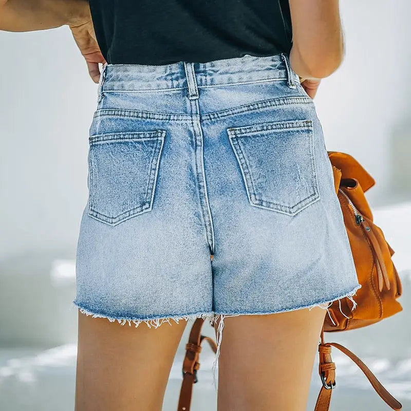 Light blue high waisted ripped denim shorts with frayed hems and back pockets