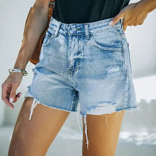 High waisted ripped blue shorts with distressed denim and frayed hems for a casual look