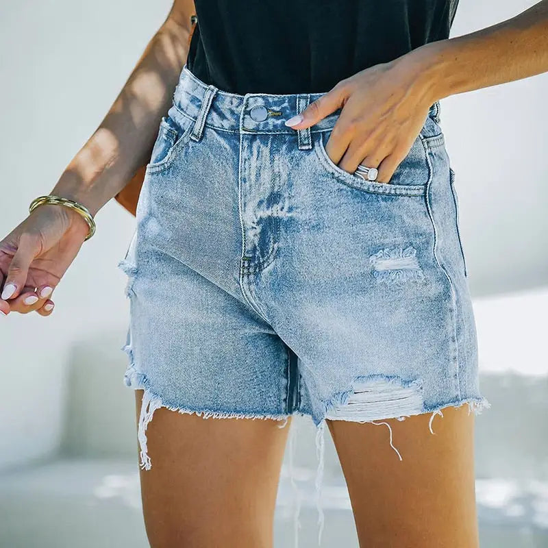 High waisted ripped blue shorts with distressed denim and frayed hems for a trendy look
