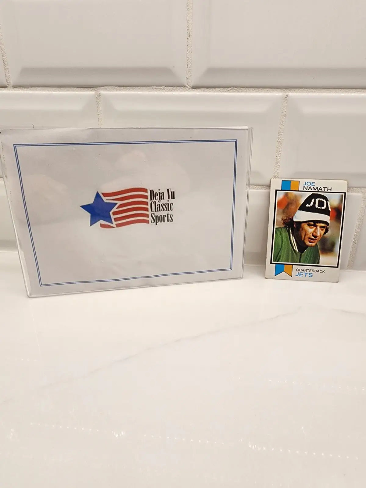 Sports memorabilia featuring a Joe Namath New York Jets football card from 1973