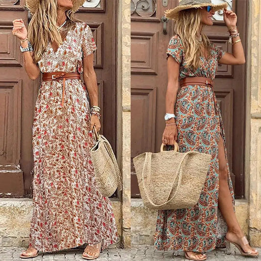 Two women wearing long paisley print V-neck summer dresses with belts and straw hats