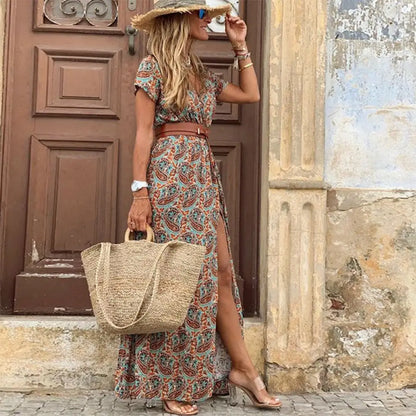 Woman in paisley print long dress with belt and straw hat for summer beach style